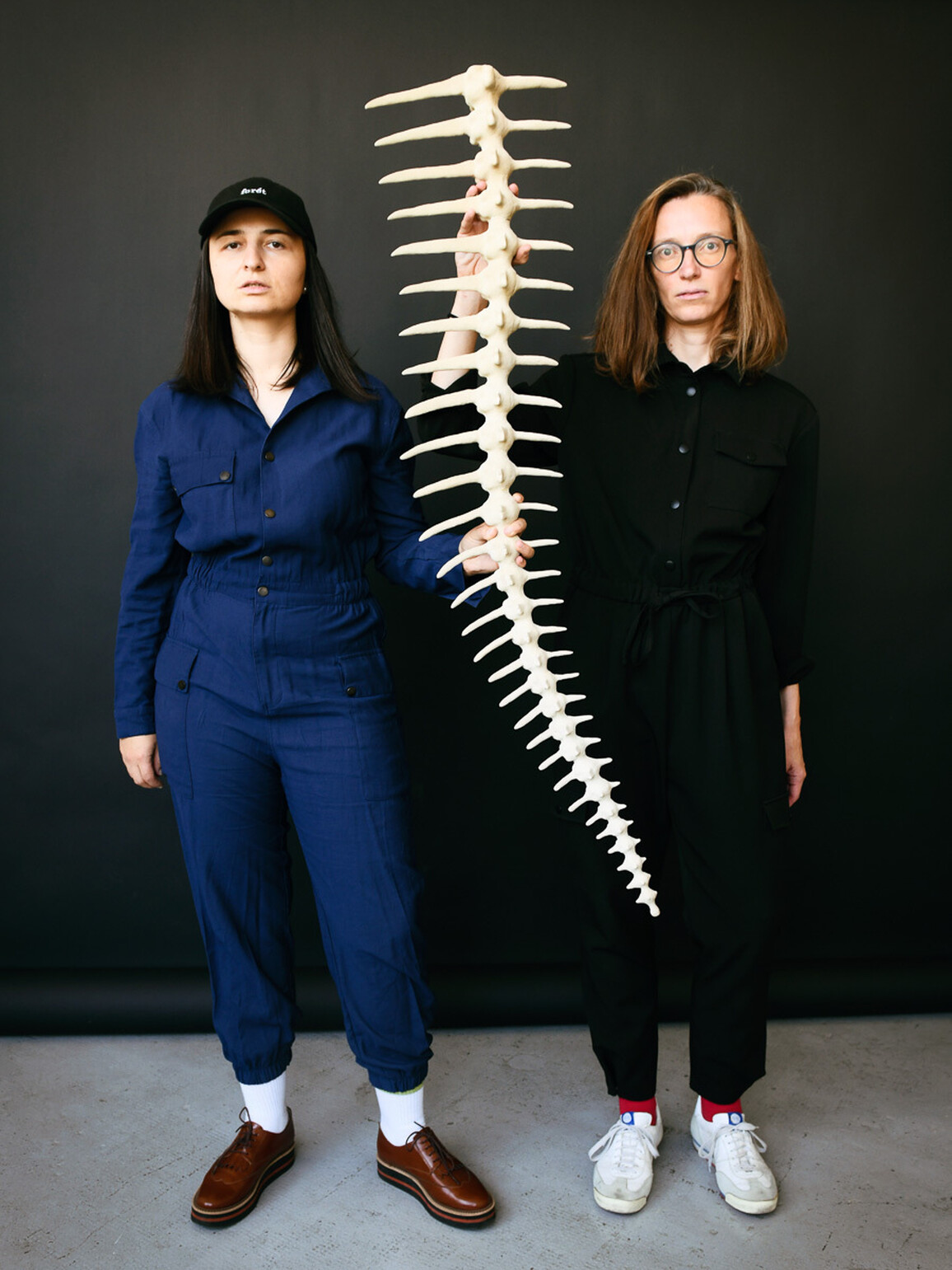Petra & Tereza holding a large spine