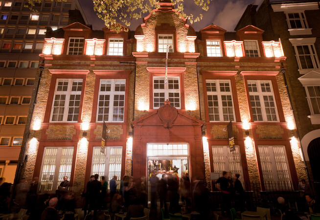 The Place building is seen from the Duke's Road entrance lit up at night