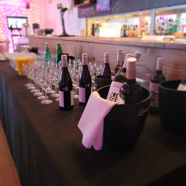 A bar of drinks on a black tablecloth