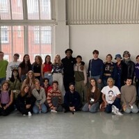 This is an image of LCDS BA1 students from 2021. A line of dancers sit down across the image. Another line of dancers stand up behind the ones sitting down.
