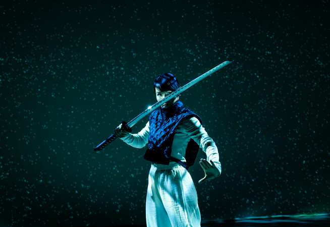 Female swordfighter posing with sword