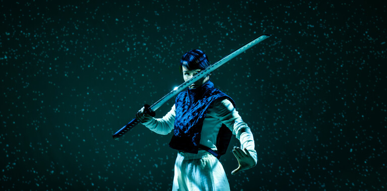 Female swordfighter posing with sword