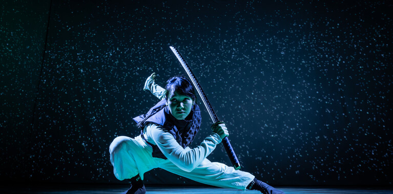 Female swordfighter in deep lunge