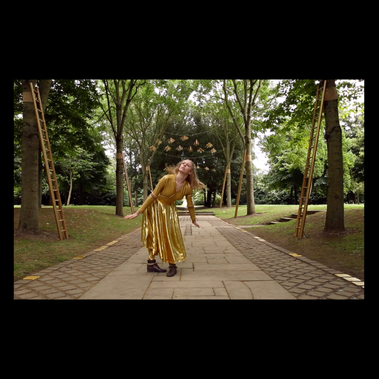 A triptych of images, the central one of a dancer amongst trees in a shimmering gold outfit, the two outer images are mirror image portraits of a fair haired little girl, thinking quizzically in vivid red.