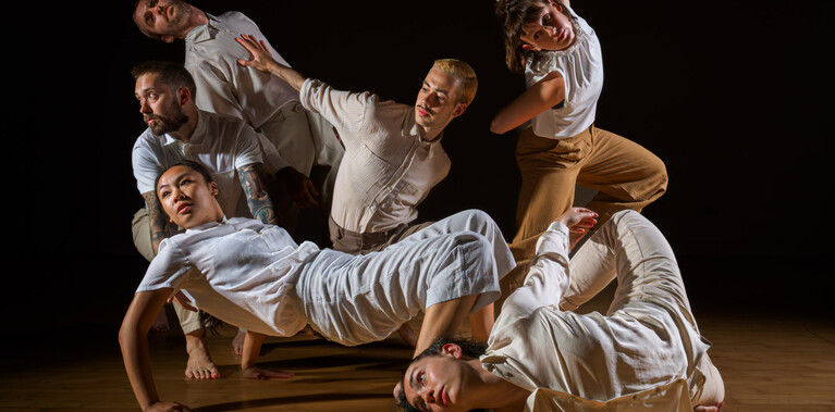 Dancers Joe Darby, Amy Morvell, Luke Brown, Yanki Ki Yau, Coralie Calfond, Ivan Merino Gaspar move as a group.